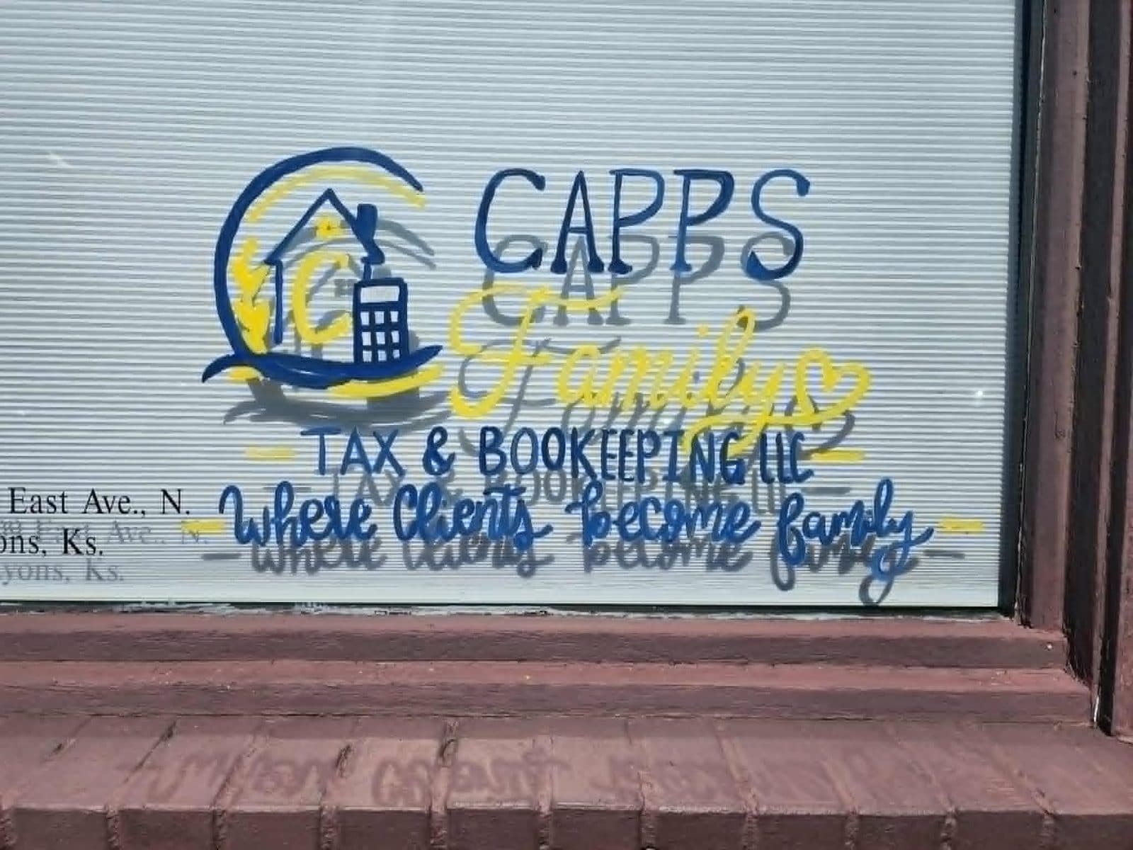 The hand-painted Capps Family Tax logo in the office window